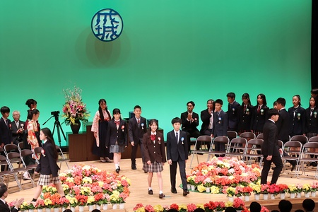 客席の大きな手拍子に合わせ卒業生が入場