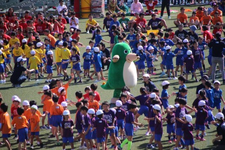 初等学校の100周年記念キャラクター「モグトカゲ」も一緒に、初等学校の子どもたちとダンス