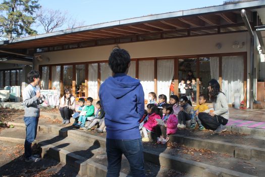 お庭に出る前にゲームの説明。後ろのお部屋からは、10月におにいさんたちと遊んだ年中さんが興味津々でのぞいています。