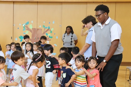 年長さん、年中さん、年少さん、留学生の順でつながって汽車をつくります