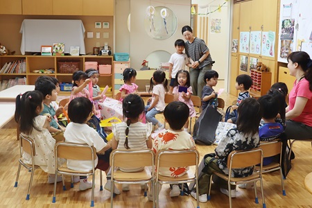 「お店やさんが開店します。来てください！」 年長さんが年少さん、年中さんに呼びかけます